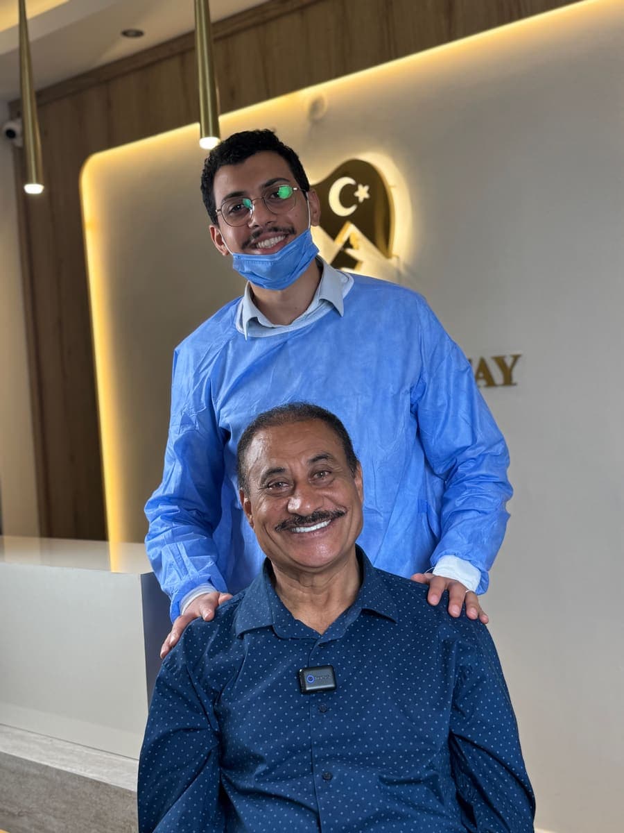 A patient with the treating dentist at TE Dent